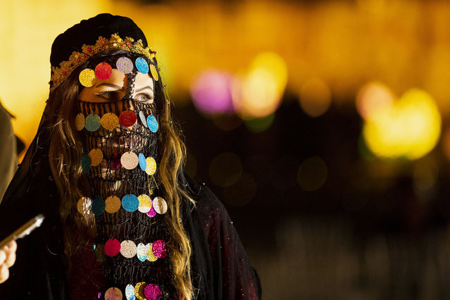 Members of a folk dance troupe prepare to perform to animate evenings during the Muslim holy fasting month of Ramadan in Iraq's southern city of Basra late on March 22, 2024. (Photo by Hussein Faleh/AFP Photo)
