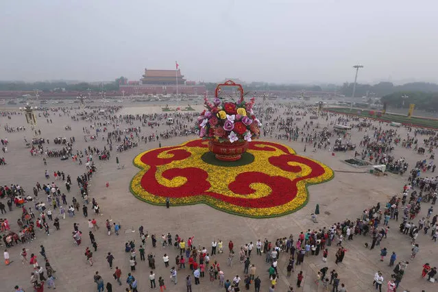 This photo taken on September 25, 2016 shows a huge “flower basket” decoration on Tiananmen Square to mark the upcoming National Day in Beijing. China will celebrate its National Day on October 1 to mark the 67th anniversary of the People's Republic of China. (Photo by AFP Photo/Stringer)