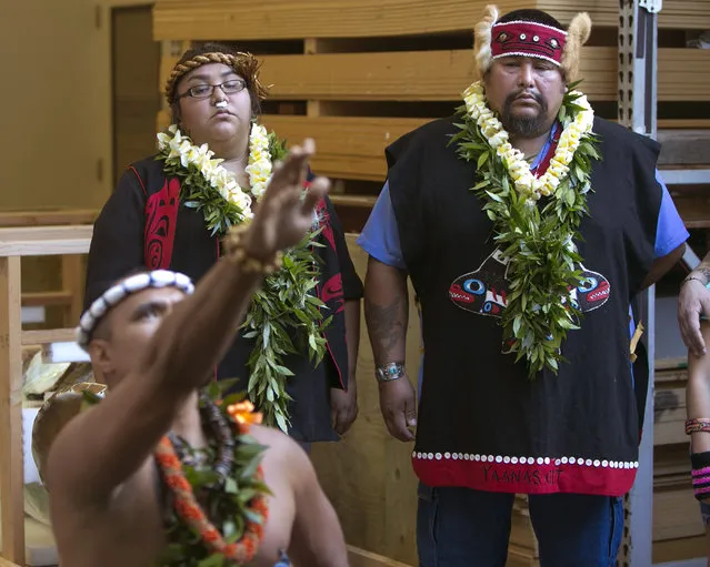 Tlingit Tribal members from Klawock, Alaska Eva Rowan, center, and Jonathan Rowan, right, watch Okolani Tallett perform a hula dance at the Honolulu Museum of Arts, Thursday, October 22, 2015, in Honolulu.   A totem pole, stolen by actor John Barrymore during a sailing trip to Alaska in 1931, was returned to the Tribe today by the Honolulu Museum of Arts where it was on display since the early 1980s. The totem pole was carved by the ancestors of the Tlingit Tribe. (Photo by Marco Garcia/AP Photo)