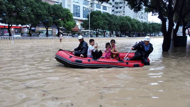 People take a boat at a flooded area as Typhoon Megi lands in Fuzhou, Fujian province, China, September 28, 2016. (Photo by Reuters/Stringer)