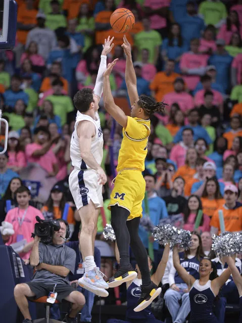 Michigan's Jett Howard,right, shoots on Penn State's Andrew Funk during the first half of an NCAA college basketball game, Sunday, January 29, 2023, in State College, Pa. (Photo by Gary M. Baranec/AP Photo)