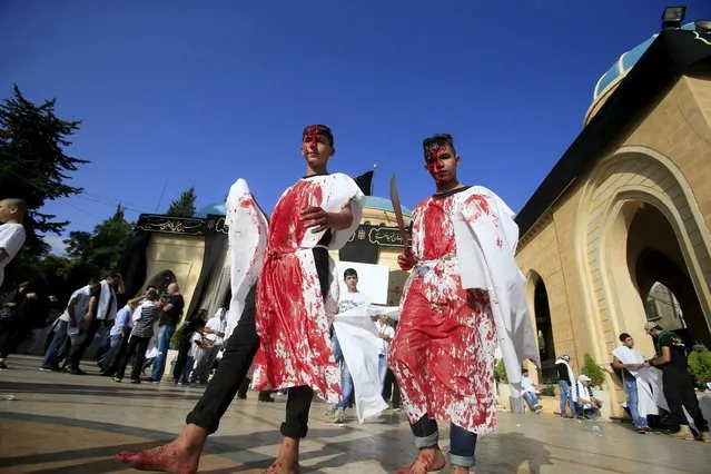 Shi'ite Muslims bleed after tapping their foreheads with a razor during a Muharram procession to mark Ashura in Nabatieh town, southern Lebanon October 24, 2015. Ashura, the most important day in the Shi'ite calendar, commemorates the death of Imam Hussein, grandson of the Prophet Mohammad, in the 7th century battle of Kerbala. (Photo by Ali Hashisho/Reuters)