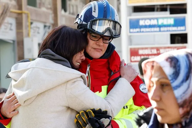A local woman thanks a rescuer of International Search and Rescue (ISAR) Germany as they search for her family, in the aftermath of an earthquake, in Kirikhan, Turkey on February 8, 2023. (Photo by Piroschka van de Wouw/Reuters)