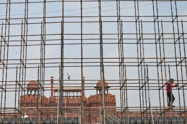 A worker secures scaffolding in front of the Red Fort, in preparation for India's 78th Independence Day celebrations on August 15, in the walled city area of the capital, New Delhi, on August 3, 2025. (Photo by Sajjad Hussain/AFP Photo)