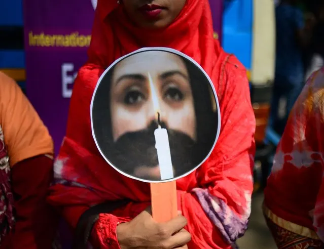 A Bangladeshi woman holding a placard takes part in a rally to mark International Women's Day in Dhaka on March 8, 2018. Thousands of Bangladeshi women, non-governmental organizations and rights groups activists took to the streets demanding safer lives for women in the country as well as an improvement in their social conditions. (Photo by Munir Uz Zaman/AFP Photo)