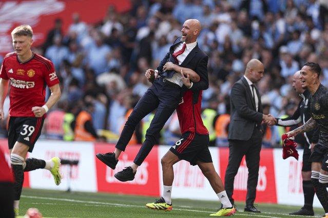 Manchester United's Lisandro Martinez liftes Manchester United's head coach Erik ten Hag while celebrating victory in the English FA Cup final soccer match between Manchester City and Manchester United at Wembley Stadium in London, Saturday, May 25, 2024. (Photo by Ian Walton/AP Photo)