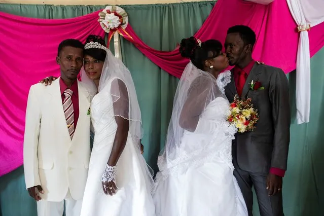 Brides Roselene Saint Juste and Mireille Mathurin, who got married in a joint wedding ceremony to cousins Sony Vernet and Herve Vernet, in order to share the costs of the reception, pose for a photograph on the day of their wedding at a church in Mariani, Haiti, April 15, 2017. In a country where more than half the population lives under the poverty line of $2.41 per day, only the wealthiest of Haitian couples can afford the full shebang of a wedding ceremony, lavish dinner reception, and honeymoon. Most have to get creative. Sometimes multiple couples get married at the same time to save on church fees. (Photo by Valerie Baeriswyl/Reuters)
