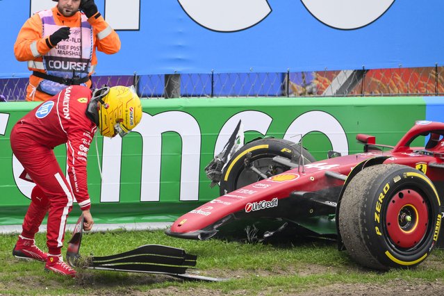 Ferrari's British driver Lewis Hamilton moves a piece of his front wing after crashing during the Formula One Dutch Grand Prix at The Circuit Zandvoort, western Netherlands, on August 31, 2025. (Photo by John Thys/AFP Photo)