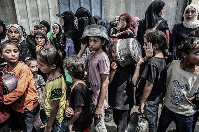 Palestinian civilians wait in line for hours for the distribution that could only serve a small number of people, in Nuseirat Refugee Camp, central Gaza, on September 01, 2025. Hot meals were distributed at the Nuseirat Refugee Camp in central Gaza to Palestinians struggling to access food due to Israel's blockade of the Gaza Strip and the deepening hunger crisis. (Photo by Moiz Salhi/Anadolu via Getty Images)