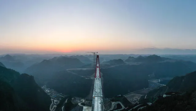 Aerial panorama view of the Longlihe Bridge in Longli County, southwest China's Guizhou Province, 29 January 2023. The 1,260-meter-long bridge is under construction. (Photo by Yang Wenbin/Xinhua News Agency via EPA)