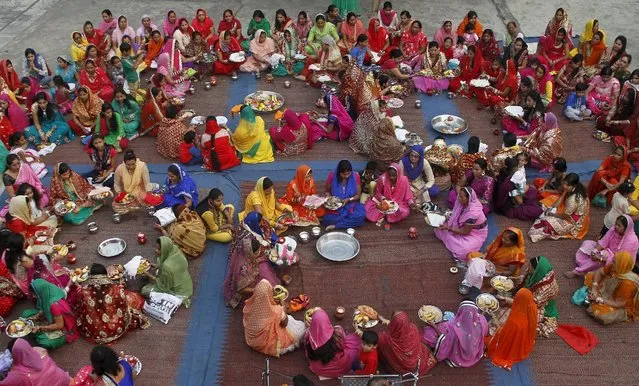 Women pray during the Hindu festival of Karva Chauth inside the premises of a temple in Chandigarh, India, October 30, 2015. (Photo by Ajay Verma/Reuters)