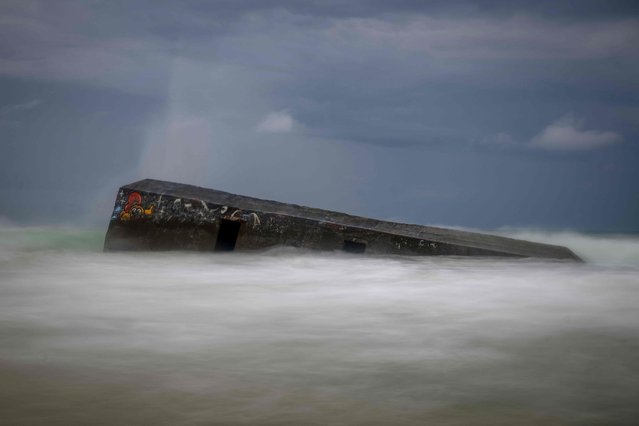 This photograph shows a partially submerged bunker (Blockhaus) from the Atlantic Wall at the entrance of Arcachon Bay near Cap Ferret, south-western France on May 19, 2024. The Atlantic Wall, made up of bunkers or blockhaus was ordered by Nazi Germany's leader Adolph Hitler to be built and between 1942 and 1944, stretched some 5000km from northern Norway to the Franco-Spanish border to defend occupied territories from sea borne attack. 15,000 of them were planned to be built, but due to insufficient manpower and material, only about half of them were completed. (Photo by Olivier Morin/AFP Photo)