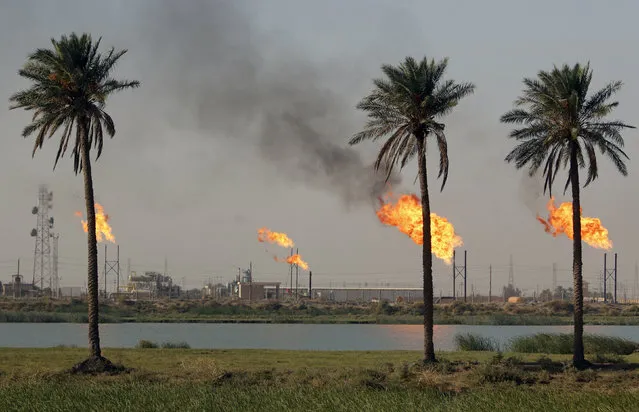 Flames emerge from a pipeline at the oil fields in Basra, southeast of Baghdad, Iraq October 14, 2016. (Photo by Essam Al-Sudani/Reuters)