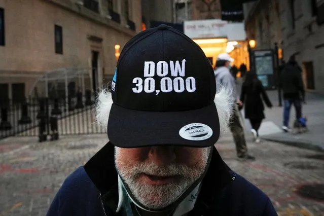 Trader Peter Tuchman wears a DOW 30,000 hat as he greets friends outside the New York Stock Exchange (NYSE) in New York, U.S., November 24, 2020. (Photo by Brendan McDermid/Reuters)