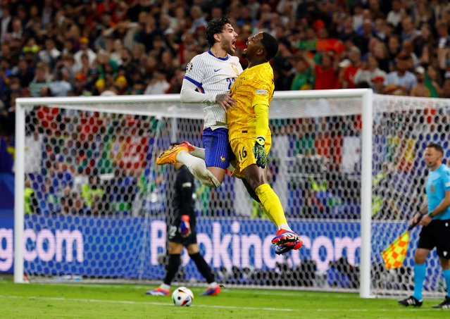 France's Mike Maignan and Theo Hernandez celebrate after winning the penalty shootout against Portugal at Hamburg Volksparkstadion in Hamburg, Germany on July 5, 2024. (Photo by Wolfgang Rattay/Reuters)