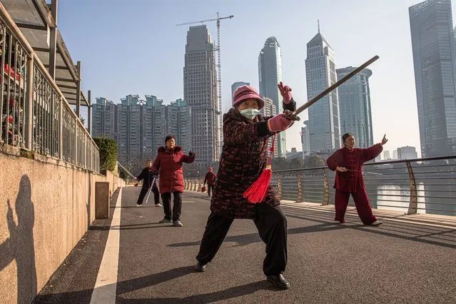 Chinese women practice tai chi next to a lake, in Wuhan, China, 02 January 2021. Life in Wuhan, a Chinese city of more than 11 million, which a year ago became the epicenter of the coronavirus outbreak, is returning to normal. (Photo by Roman Pilipey/EPA/EFE)