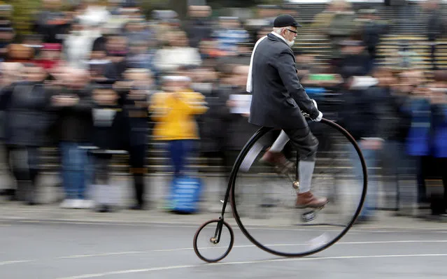 A participant wearing a historical costume rides his high-wheel bicycle during the annual penny farthing race in Prague, Czech Republic November 5, 2016. (Photo by David W. Cerny/Reuters)