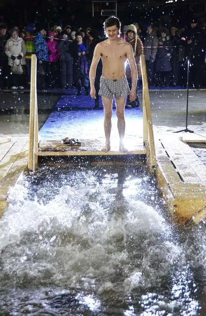 A man gets ready before immersing himself in an ice hole in the Sea of Japan, at a temperature of about minus 7 Celsius, during celebrations for Russian Orthodox Epiphany in Amur Bay, in Russia's far eastern port of Vladivostok January 18, 2015. (Photo by Yuri Maltsev/Reuters)