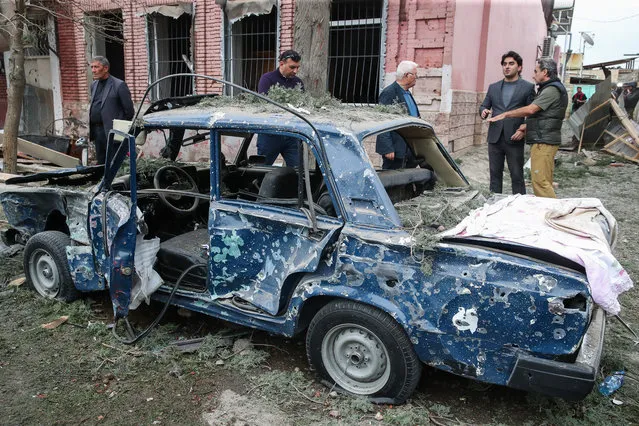 A car damaged by rocket fire in Gyandzha, Azerbaijan on October 4, 2020. The situation in Nagorno-Karabakh (Artsakh) escalated September 27, 2020, with reports from Yerevan on the Azerbaijani troops advancing in the direction of Nagorno-Karabakh and shelling its settlements, including the capital city of Stepanakert. Both Azerbaijan and Armenia have declared martial law and mobilized their armed forces, reporting on casualties and injuries among civilians as well. (Photo by Valery Sharifulin/TASS)