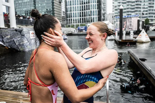 In this handout image provided by Red Bull, Xantheia Pennisi (L) of Australia and Molly Carlson of Canada celebrate during the final competition day of the first stop of the Red Bull Cliff Diving World Series on June 03, 2023 at Boston, Massachusetts. (Photo by Romina Amato/Red Bull via Getty Images)