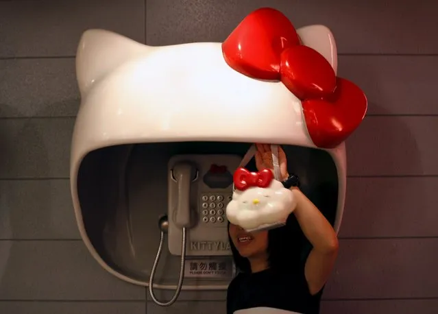 A visitor poses in front of a mock telephone booth inside the “Kitty Lab”, a simulated city environment of Hello Kitty, to celebrate the character's 35th anniversary, inside an exhibition centre in Hong Kong in this August 12, 2009 file photo. More than three million accounts of Hello Kitty fans were left vulnerable to theft by hackers, but there is no evidence any data has been stolen, the Hong Kong-based company hosting the data said on December 22, 2015. (Photo by Bobby Yip/Reuters)