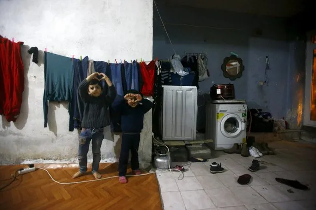 Syrian refugee boys pose as his mother takes part in an interview with Reuters in Istanbul, Turkey, December 16, 2015. (Photo by Osman Orsal/Reuters)