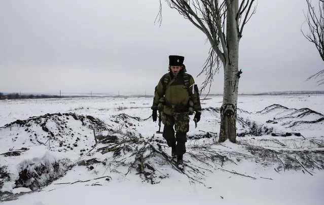 A pro-Russian separatist looks on in the outskirts of Vuhlehirsk, eastern Ukraine February 10, 2015. (Photo by Maxim Shemetov/Reuters)