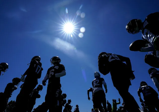 Members of the Seattle Seahawks offense, including wide receiver Matt Landers (17), wide receiver Tyler Lockett (16) and running back SaRodorick Thompson Jr. (29) warm up during the NFL football team's training camp, Thursday, August 3, 2023, in Renton, Wash. (Photo by Lindsey Wasson/AP Photo)