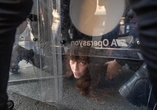 Turkish police detains a demonstrator as they clash during a May Day rally marking the international day of the worker in Istanbul, on May 1, 2021. With the highest infection rate in Europe, Turkey enters a full lockdown until May 17, with all non-essential businesses to close and travel between regions restricted. Alcohol sales at groceries and chain stores will be banned to prevent unfair competition with closed small liquor stores. (Photo by Bulent Kilic/AFP Photo)