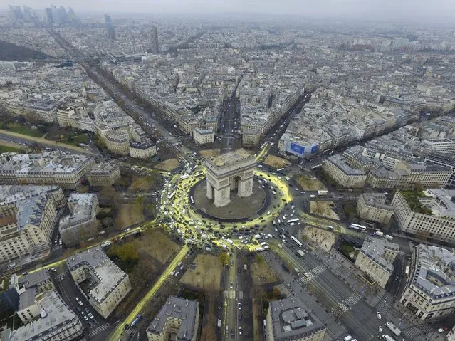 Yellow paint, symbolising the sun and its rays, is seen around the Arc de Triomphe during a protest on Champs Elysees avenue on the sidelines of the World Climate Change Conference 2015 (COP21), in Paris, France, in this handout photo taken and distributed December 11, 2015 by Greenpeace. (Photo by Reuters/Greepeace)