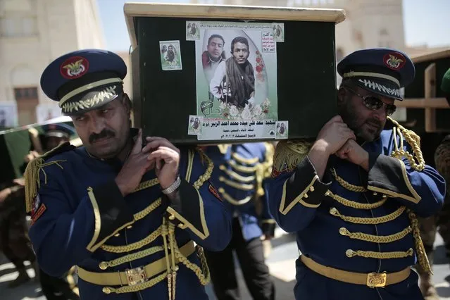 In this Februry 16, 2021 file photo, honor guards carry coffins adorned with photographs of Houthi rebel fighters who who were killed in recent fighting with forces of Yemen's Saudi-backed internationally recognized government during their funeral procession, in Sanaa, Yemen. An offensive by Yemen's Iran-backed Houthi rebels in the province of Marib has already displaced hundreds of thousands, but it is also sparking fighting on the country's other front lines and endangering peace efforts to end the grinding civil war. (Photo by Hani Mohammed/AP Photo/File)