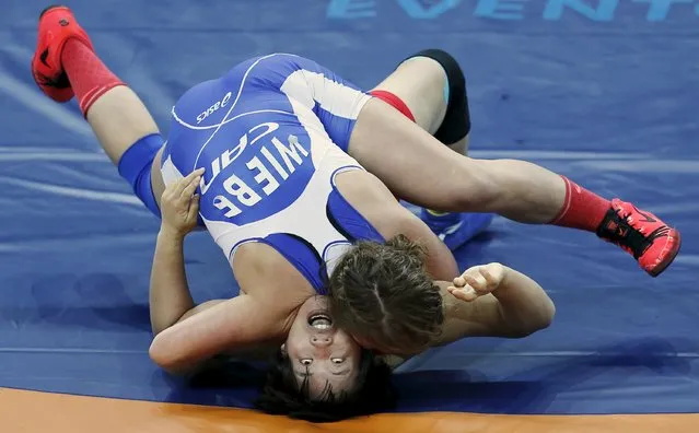 Erica Wiebe (blue) of Canada fights with Zhang Fengliu of China during their women's 75 Kg Freestyle wrestling, a test event for the Rio 2016 Olympic Games, at the Arena Carioca 1 in the Rio 2016 Olympic Park in Rio de Janeiro, Brazil, January 31, 2016. (Photo by Sergio Moraes/Reuters)