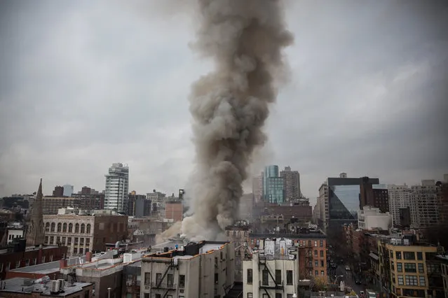 Smoke rises from a burning building after an explosion on 2nd Avenue on March 26, 2015 in New York City.  (Photo by Andrew Burton/Getty Images)