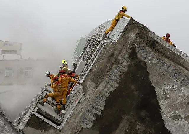 Rescue personnel work at the site where a 17-storey apartment building collapsed, after an earthquake in Tainan, southern Taiwan, February 6, 2016. (Photo by Patrick Lin/Reuters)