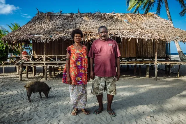Mike and Alice are villagers from Killerton, Papua New Guinea, where they live in the house they built themselves several years ago. They were displaced from their village when a flood tore through it in 2007. Before the water could reach them, Mike and a few villagers managed to saw his home in half and move it out of the path of the deluge before repairing it again. They continue to live in the same house. (Photo by Muse Mohammed/IOM)