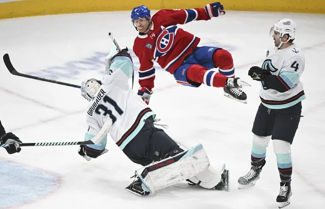 Montreal Canadiens' Mike Matheson, center, collides with Seattle Kraken goaltender Philipp Grubauer (31) as Kraken's Justin Schultz (4) looks on during the first period of an NHL hockey match in Montreal, Monday, December 4, 2023. (Photo by Graham Hughes/The Canadian Press via AP Photo)