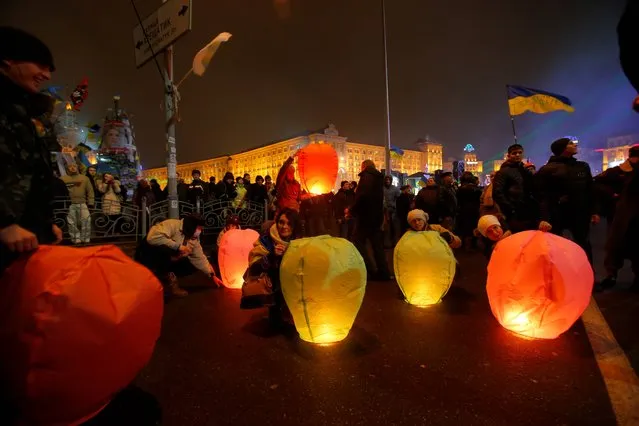 Pro-European Union activists launch flying lanterns during a rally in Independence Square in Kiev, Ukraine, Monday, Dec. 16, 2013. Weeks of angry pro-European Union protests as well as Western pressure have forced Yanukoyvch to make some concessions to the opposition. Last week Yanukovych called for an amnesty for some of the activists detained. (Photo by Sergei Grits/AP Photo)