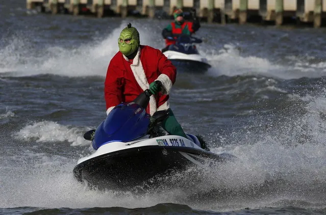 A water skier dressed as the Grinch skis in the Potomac River at National Harbor to celebrate Christmas Eve in Maryland, December 24, 2013. (Photo by Larry Downing/Reuters)