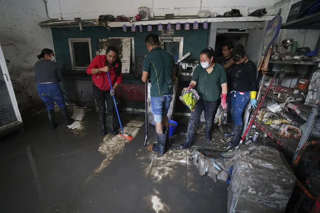 Locals start clean-up and recovery work after floods in downtown Tula, Hidalgo state, Mexico, Thursday, September 9, 2021. Teams continued evaluating the damage from flooding that swamped downtown Tula, when the Tula River jumped its banks. (Photo by Marco Ugarte/ AP Photo)