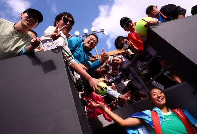 China's Qinwen Zheng celebrates with fans after winning their second round match against Britain's Katie Boulter at the Australian Open in Melbourne on January 18, 2024. (Photo by Edgar Su/Reuters)