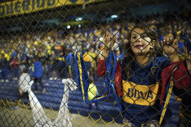 A young Boca Juniors' fan watches the Superliga women's tournament soccer match between Boca Juniors and Lanus in Buenos Aires, Argentina, Saturday, March 9, 2019. (Photo by Natacha Pisarenko/AP Photo)