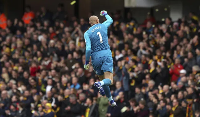 Watford goalkeeper Heurelho Gomes celebrates after teammate Etienne Capoue scores his side's first goal of the game  during the FA Cup quarter final soccer match between Watford and Crystal Palace , at Vicarage Road, in Watford, England, Saturday March 16, 2019. (Photo by Jonathan Brady/PA Wire via AP Photo)