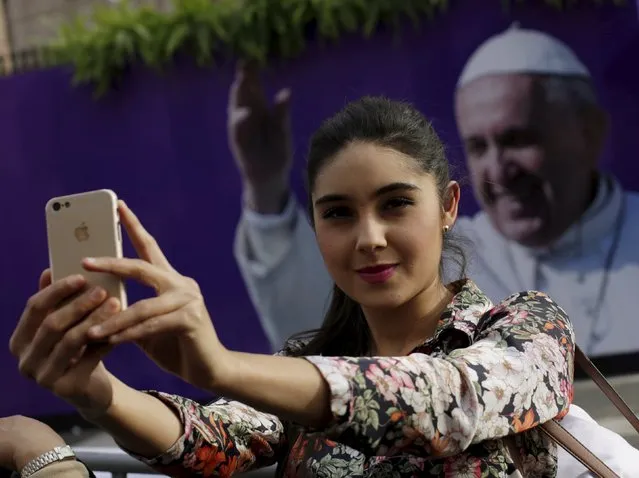 A woman takes a selfie in front of an image of Pope Francis, outside the Cathedral, ahead of his visit to Morelia in the Mexican state of Michoacan February 15, 2016. (Photo by Henry Romero/Reuters)