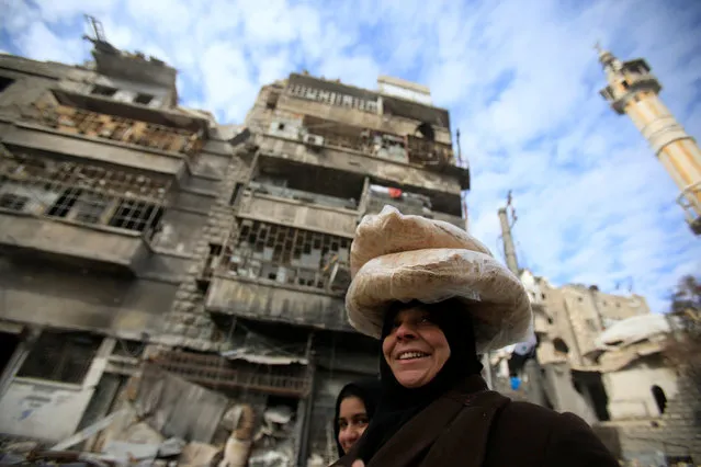 A woman carries bread on her head in Aleppo, Syria January 30, 2017. (Photo by Ali Hashisho/Reuters)