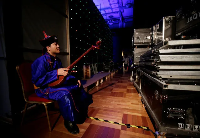 An Inner Mongolian singer waits to perform backstage before Eji's pastoral song Autumn/Winter collection show during the China Fashion Week in Beijing, China, March 27, 2019. (Photo by Jason Lee/Reuters)