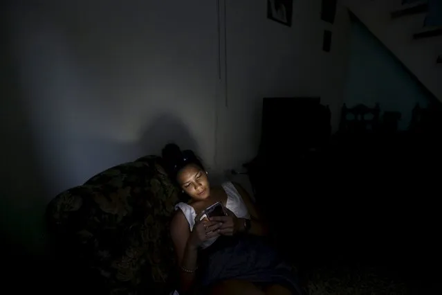 Katherine, 20, uses her cell phone in her house in Havana March 16, 2016. (Photo by Enrique de la Osa/Reuters)