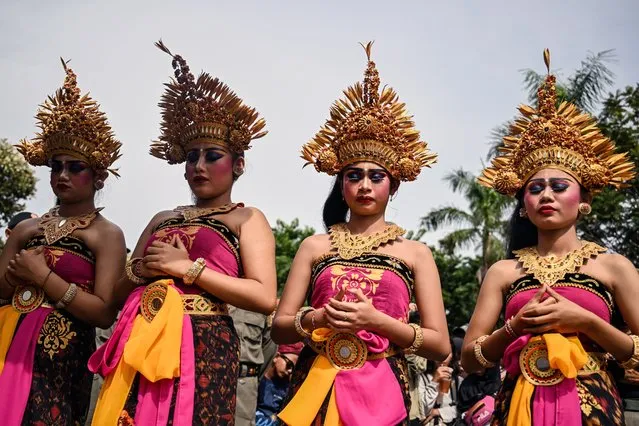 Dancers wait to perform before Hindus devotees take part in the Ogoh-Ogoh effigy parade on the eve of Nyepi, the day of silence, in Surabaya on March 10, 2024. Hindus in Indonesia, the world's largest Muslim-populated nation, will celebrate the “Day of Silence”, locally known as Nyepi, on March 11. (Photo by Juni Kriswanto/AFP Photo)