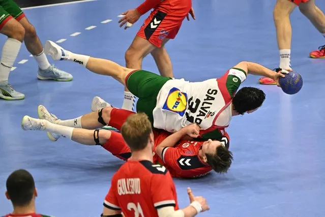 Norway's center back Sander Sagosen (down) fights for the ball with Portugal's goalkeeper Gustavo Capdeville (top) during the men's Handball Olympic qualifying match between Norway and Portugal in Tatabanya, Hungary on March 14, 2024. (Photo by Attila Kisbenedek/AFP Photo)