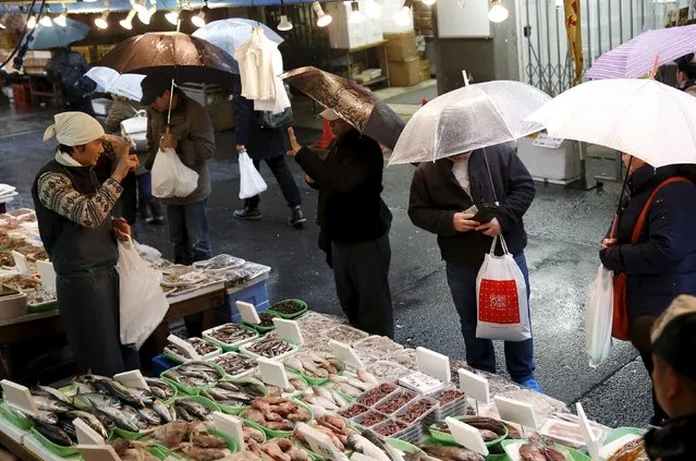 People look at seafood at a stall at a shopping district in Tokyo, Japan, March 14, 2016. (Photo by Yuya Shino/Reuters)