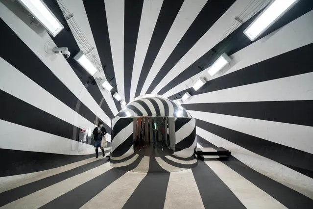 A visitor looks at an installation as part of the artwork “Tunnel of Light” (Echigo-Tsumari Art Field) by Ma Yansong / MAD Architects at the Kiyotsu-kyo Gorge on November 21, 2021 in Tokamachi, Japan. (Photo by Tomohiro Ohsumi/Getty Images)